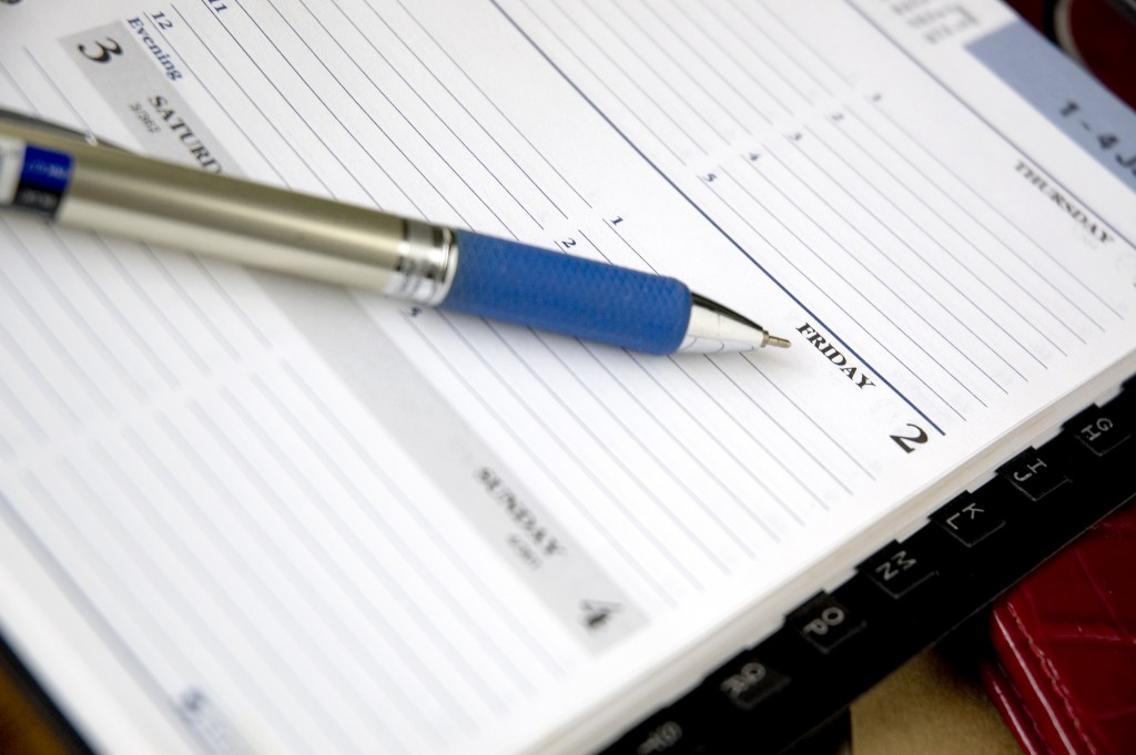 A pen pointing to Friday on an agenda