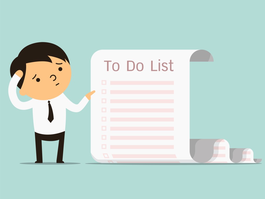 Businessman confused with long paper note with to do list.