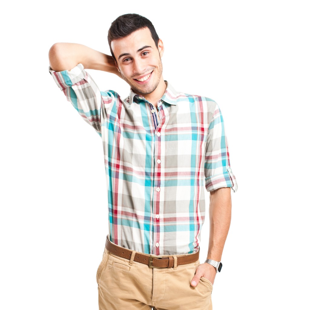 Happy young man looking at camera with embarrassment